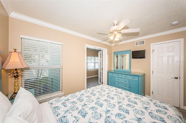 bedroom with ceiling fan, hardwood / wood-style floors, and ornamental molding