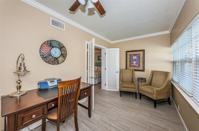 home office featuring a textured ceiling, ornamental molding, and ceiling fan