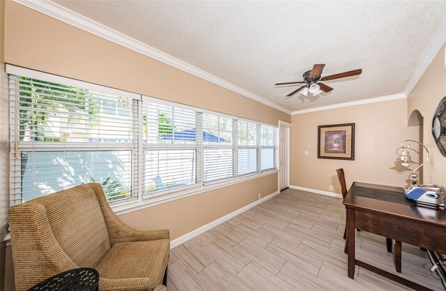 office area featuring ceiling fan, a textured ceiling, plenty of natural light, and ornamental molding