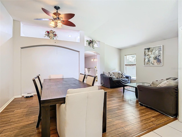 dining area with vaulted ceiling, ceiling fan, and hardwood / wood-style flooring