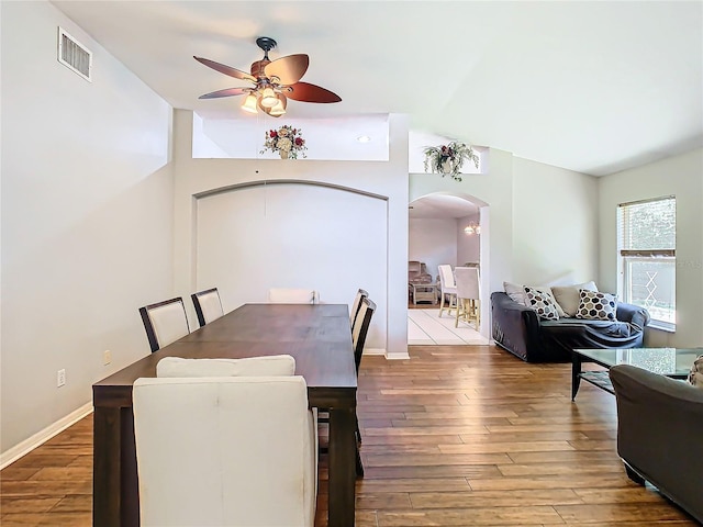 dining area with vaulted ceiling, hardwood / wood-style floors, and ceiling fan