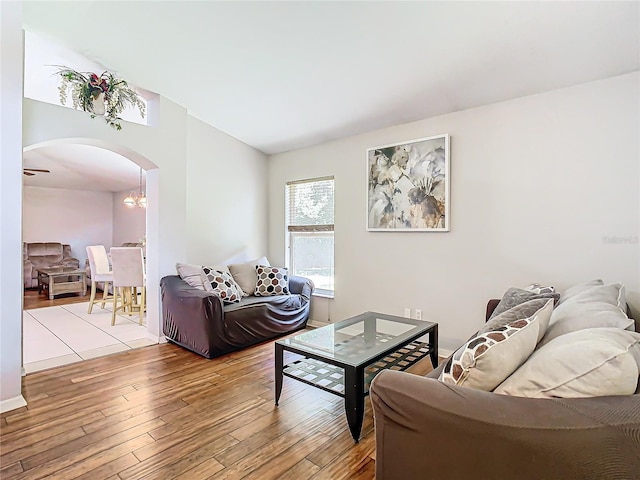 living room with a notable chandelier and light wood-type flooring