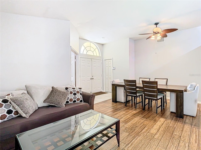 living room featuring light wood-type flooring and ceiling fan