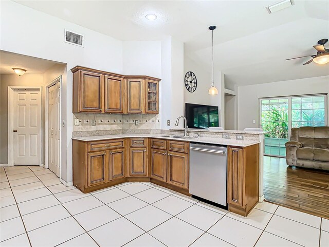 kitchen featuring light tile patterned flooring, dishwasher, ceiling fan, decorative light fixtures, and sink