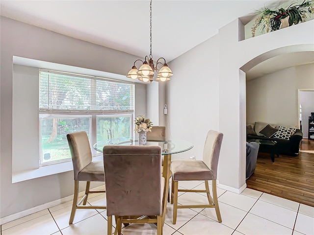 tiled dining space with plenty of natural light and a chandelier