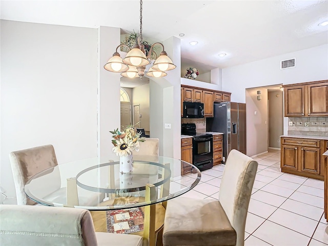 dining room featuring an inviting chandelier and light tile patterned floors