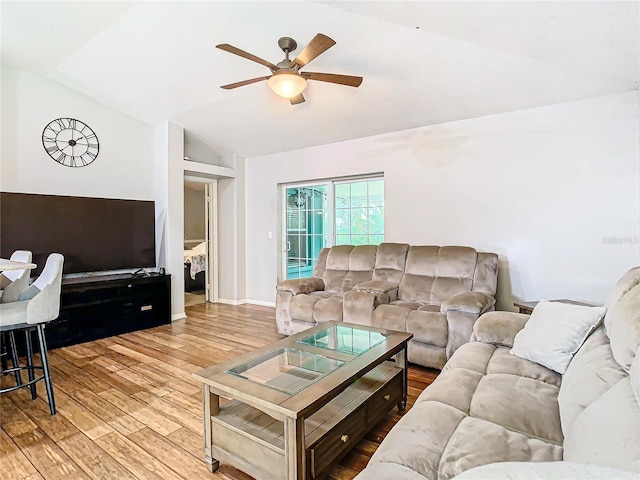 living room with ceiling fan, lofted ceiling, and light hardwood / wood-style floors