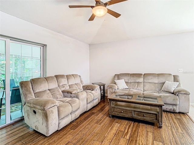 living room featuring wood-type flooring, lofted ceiling, and ceiling fan