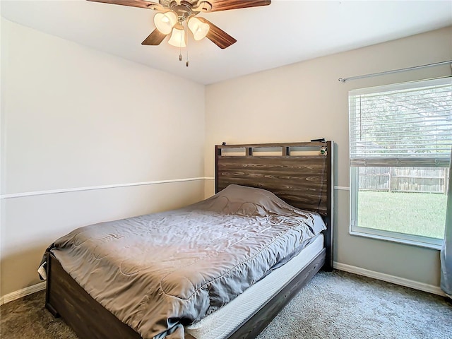 bedroom with dark colored carpet and ceiling fan