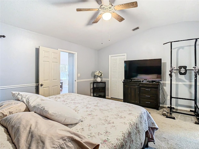 bedroom featuring a closet, vaulted ceiling, ceiling fan, and light colored carpet