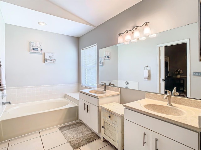 bathroom with vanity, lofted ceiling, tile patterned floors, and a tub