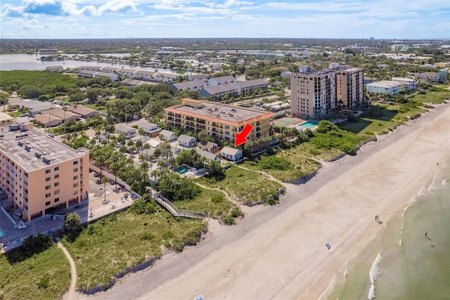 drone / aerial view featuring a view of the beach and a water view