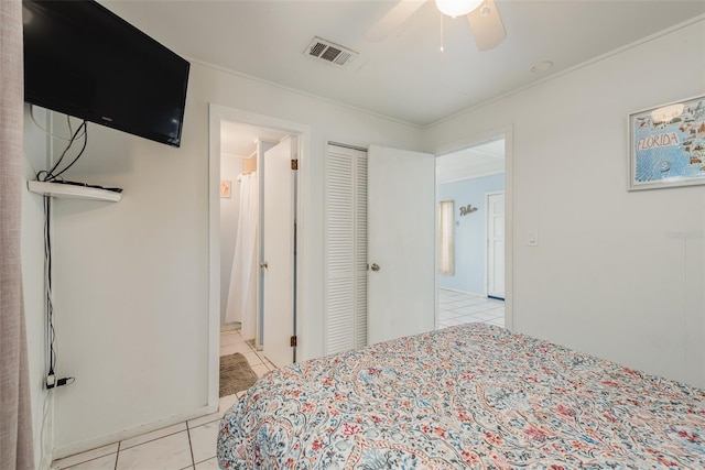 bedroom featuring light tile patterned flooring, ceiling fan, and a closet