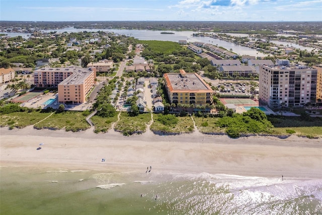 birds eye view of property with a beach view and a water view