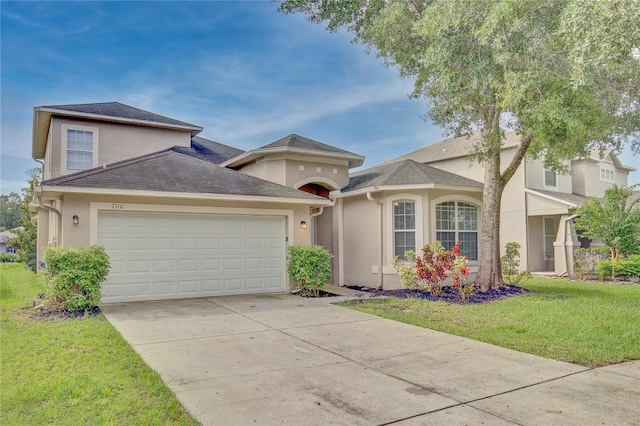 view of front of home with a garage and a front lawn