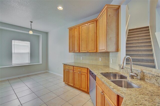 7110 Moss Ledge Run, Land O Lakes, FL 34637 - kitchen featuring stainless steel dishwasher, light stone counters, decorative backsplash, light tile patterned floors, and a sink