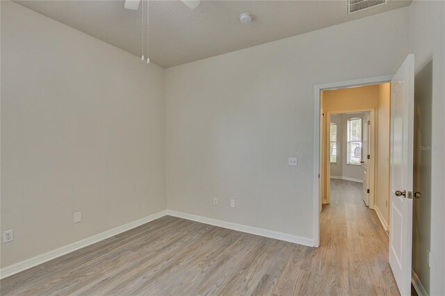 7110 Moss Ledge Run, Land O Lakes, FL 34637 - unfurnished room featuring visible vents, light wood-type flooring, ceiling fan, and baseboards