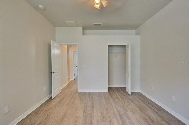 7110 Moss Ledge Run, Land O Lakes, FL 34637 - unfurnished bedroom with visible vents, baseboards, light wood finished floors, and a closet