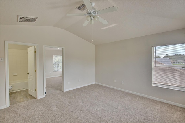 7110 Moss Ledge Run, Land O Lakes, FL 34637 - carpeted spare room featuring baseboards, visible vents, a ceiling fan, and vaulted ceiling
