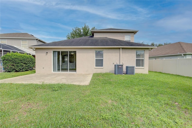7110 Moss Ledge Run, Land O Lakes, FL 34637 - rear view of property with stucco siding, fence, a patio area, central AC, and a lawn