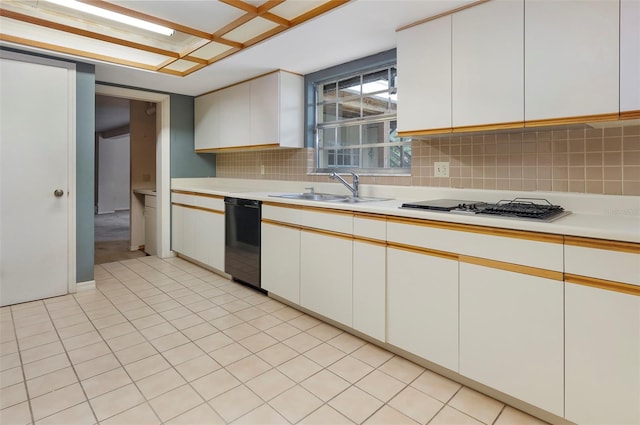 kitchen with decorative backsplash, white gas cooktop, black dishwasher, sink, and white cabinets