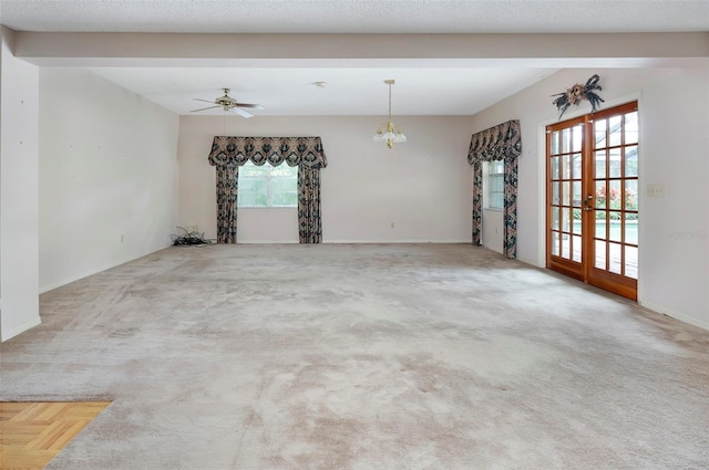 carpeted spare room with french doors, a textured ceiling, and ceiling fan