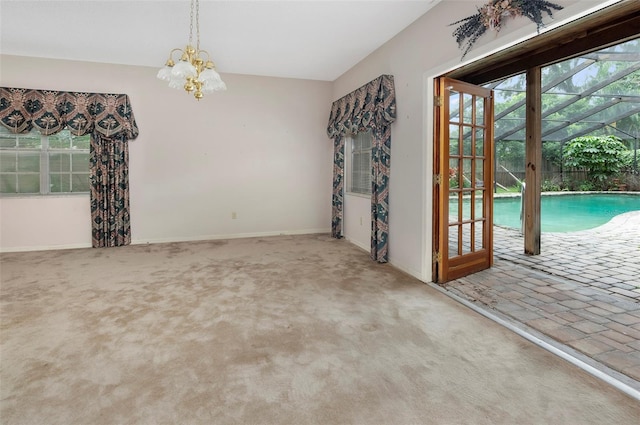 empty room with a wealth of natural light and carpet