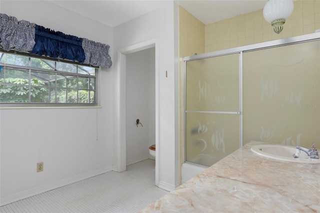 bathroom featuring toilet, sink, tile patterned flooring, and an enclosed shower