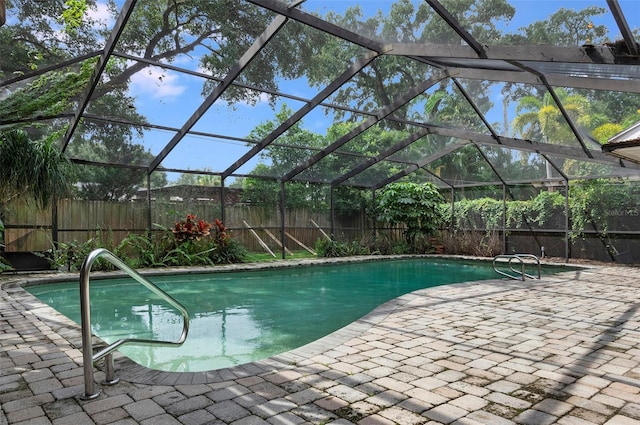 view of pool with a patio area and a lanai