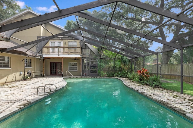 view of pool featuring a patio, french doors, and glass enclosure