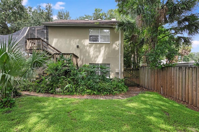 view of side of property featuring a yard