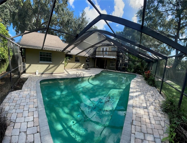 view of pool featuring a patio area and glass enclosure