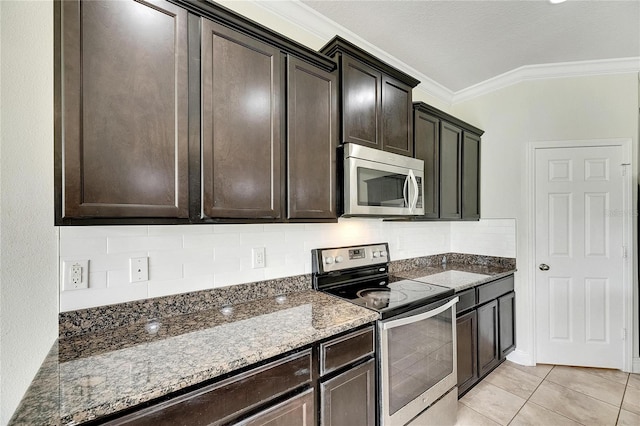 kitchen featuring ornamental molding, light tile patterned floors, stone countertops, dark brown cabinets, and appliances with stainless steel finishes