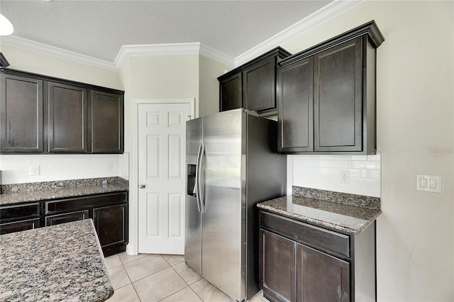 kitchen featuring a textured ceiling, light tile patterned floors, stainless steel fridge with ice dispenser, and tasteful backsplash