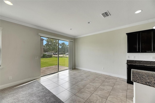 interior space featuring a textured ceiling and crown molding