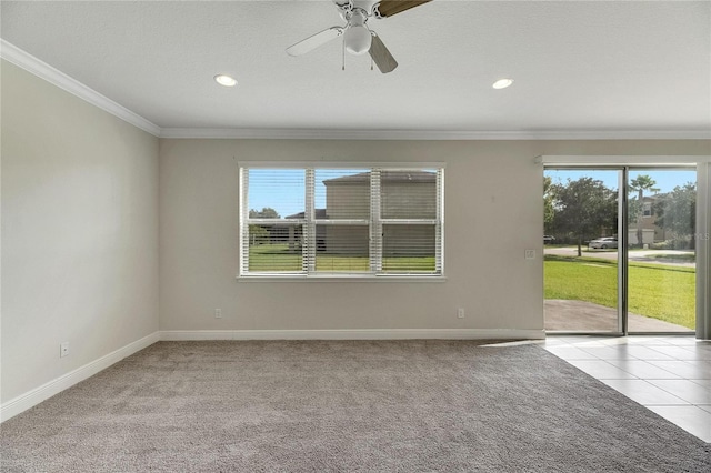 spare room with ceiling fan, light colored carpet, and ornamental molding