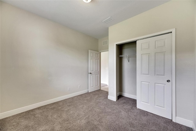 unfurnished bedroom featuring a closet and carpet floors