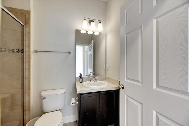 bathroom featuring vanity, toilet, and a shower with door