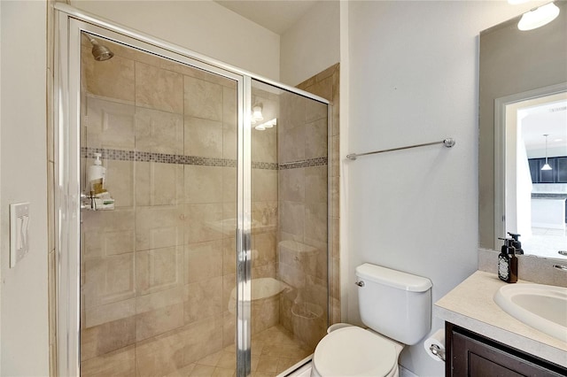 bathroom with vanity, toilet, and an enclosed shower