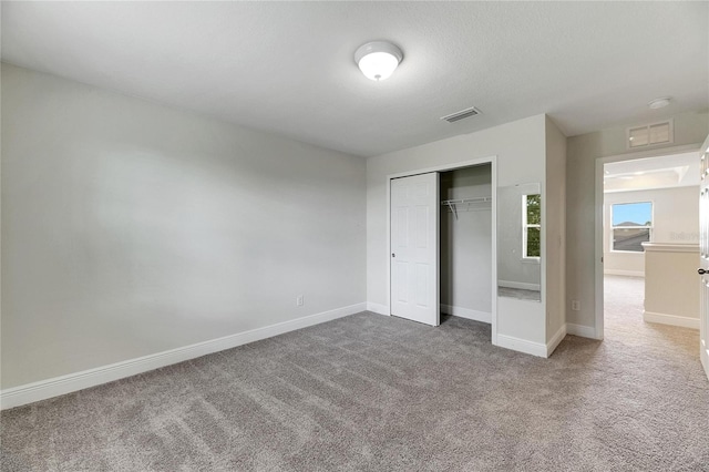 unfurnished bedroom with carpet and a closet