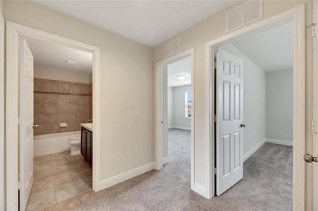 hallway with light colored carpet