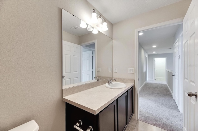 bathroom featuring vanity and toilet