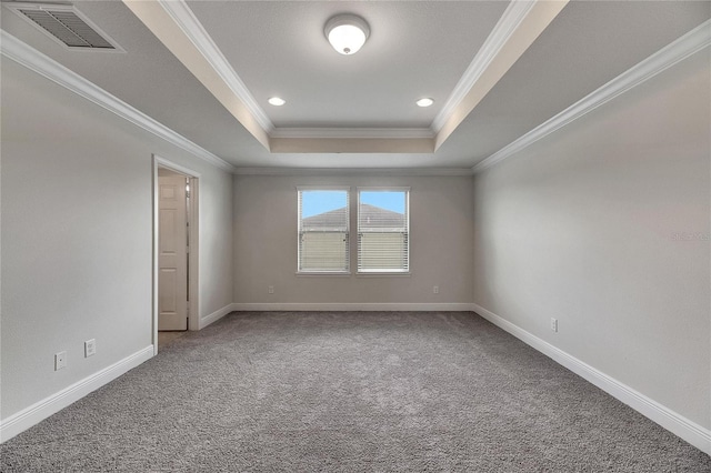 spare room featuring carpet floors, ornamental molding, and a tray ceiling