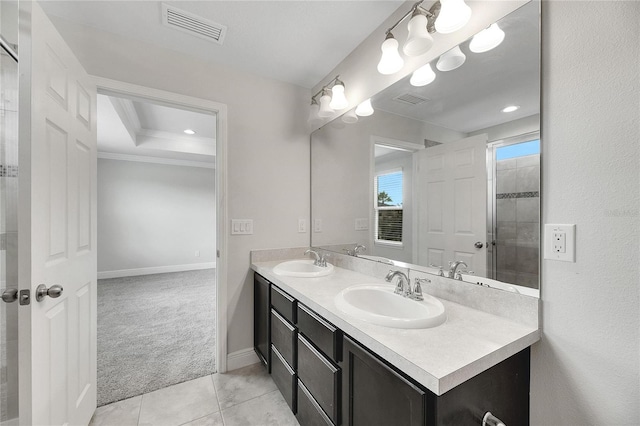 bathroom with tile patterned floors, a shower, and vanity