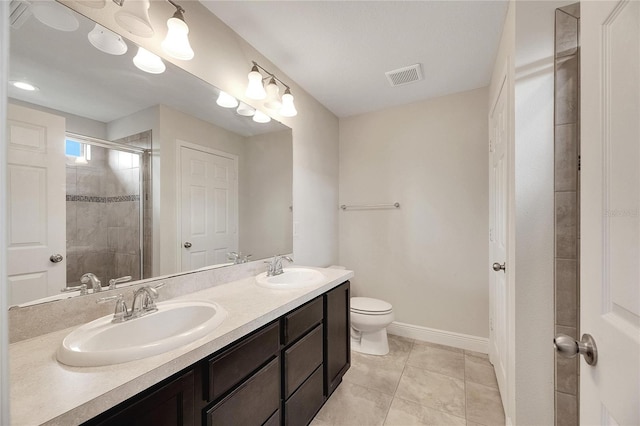 bathroom with vanity, tile patterned flooring, toilet, and a shower with door