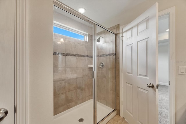 bathroom featuring a shower with shower door