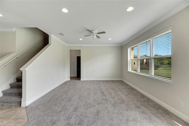 carpeted empty room featuring ornamental molding and ceiling fan