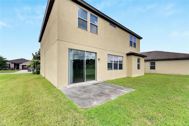 back of house featuring a lawn and a patio