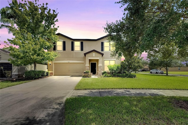 view of front facade featuring a lawn and a garage