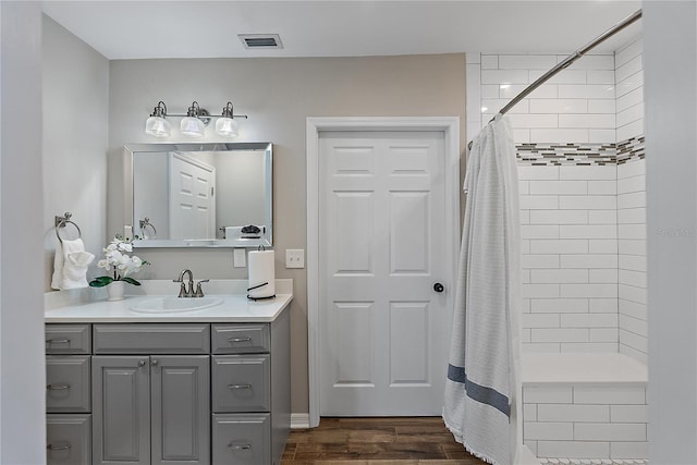 bathroom featuring hardwood / wood-style floors, vanity, and a shower with shower curtain